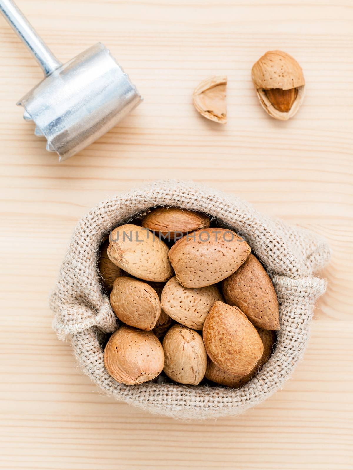 Almonds kernels and whole almonds on wooden background. Whole an by kerdkanno