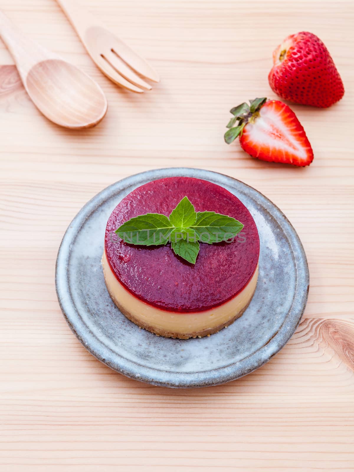 Strawberry cheesecake with fresh mint leaves on wooden backgroun by kerdkanno
