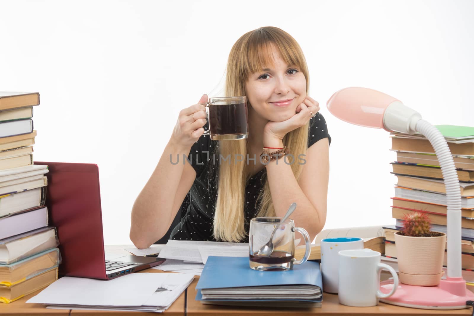 Student drinking another cup of coffee by preparing for the exam at night