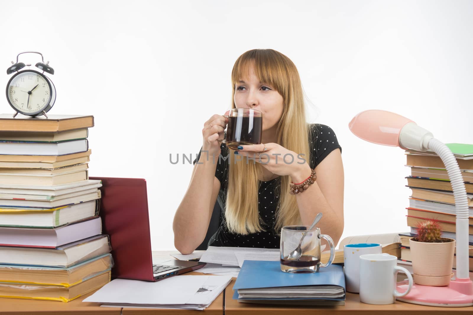 Student drinking coffee by preparing for the exam at night