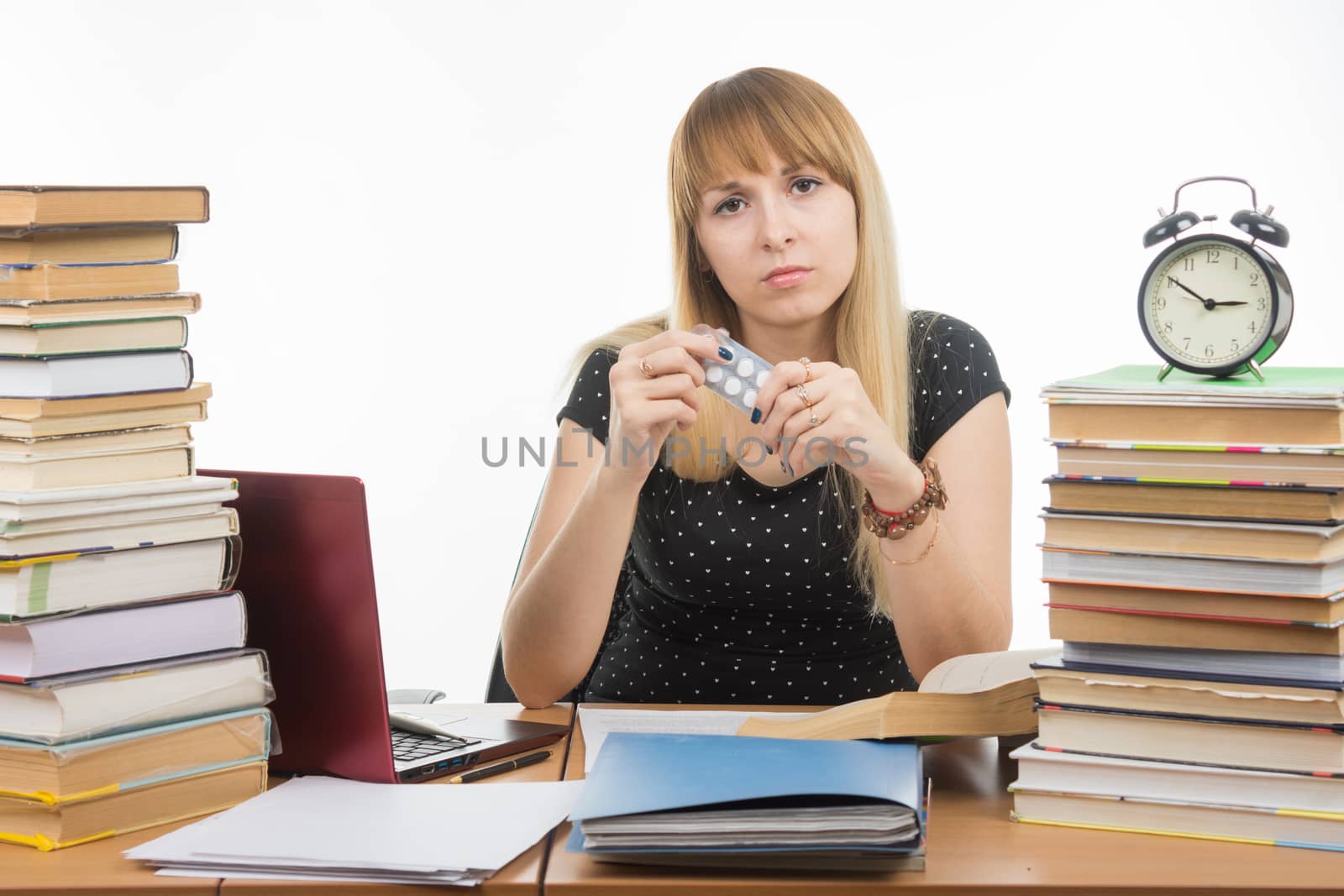 Diseased student sitting at the table with tablets in hands