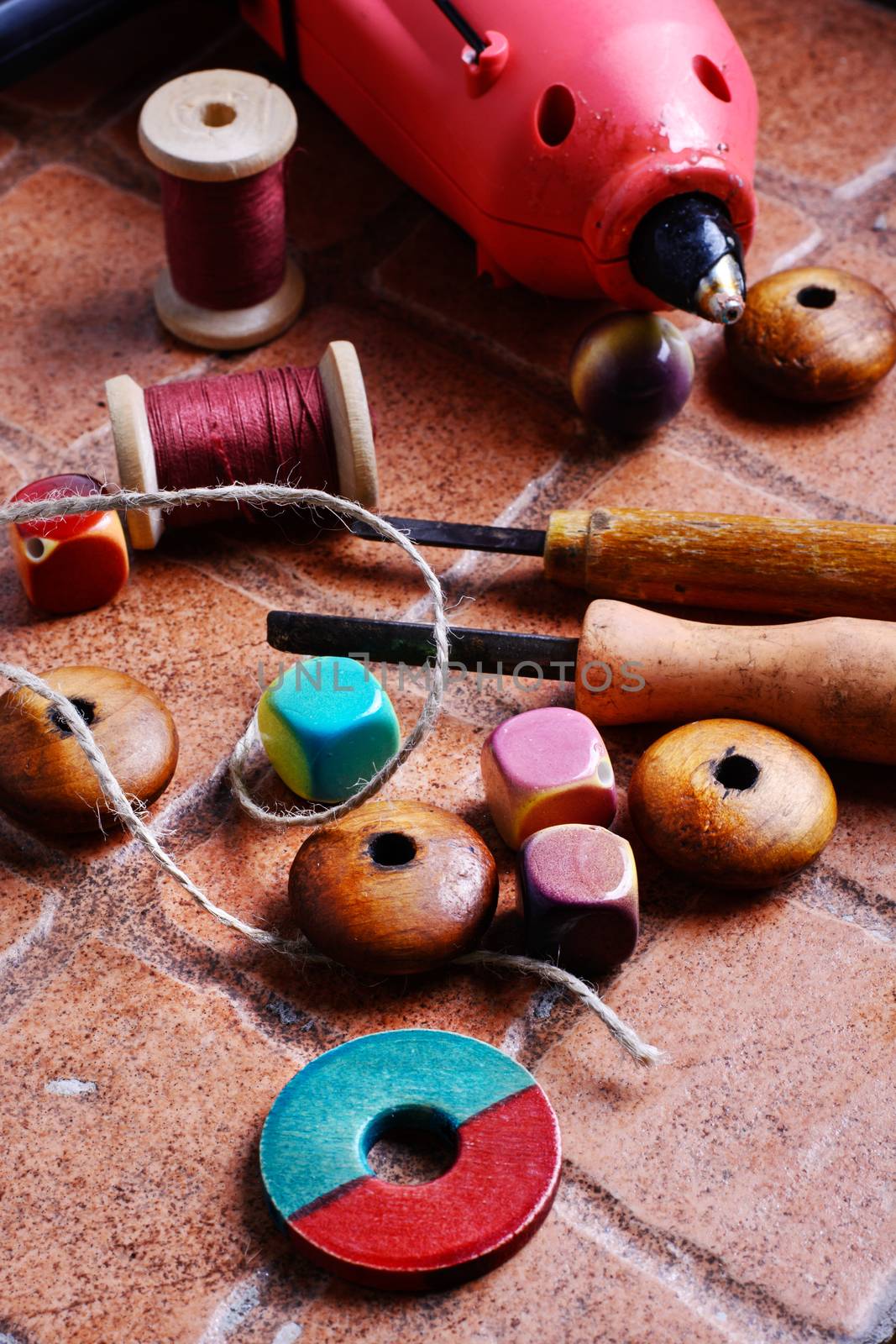 Glue gun for crafts,beads,decor and tools on a brick background
