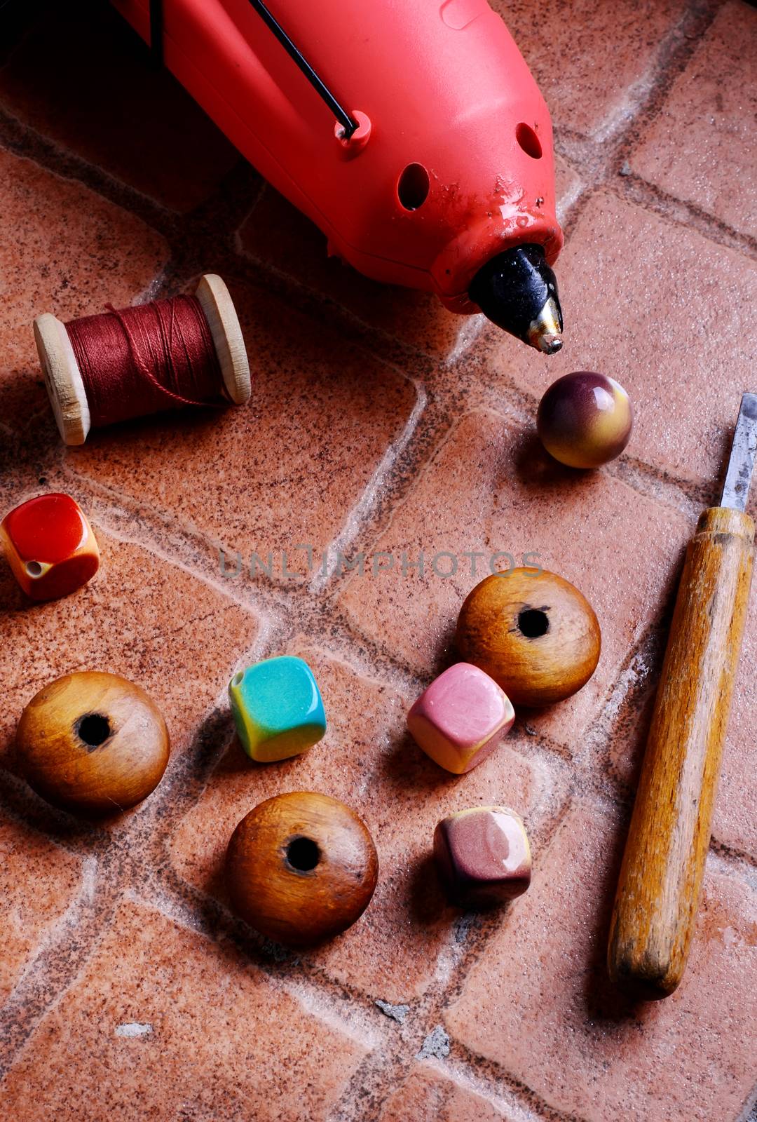 Glue gun for crafts,beads,decor and tools on a brick background