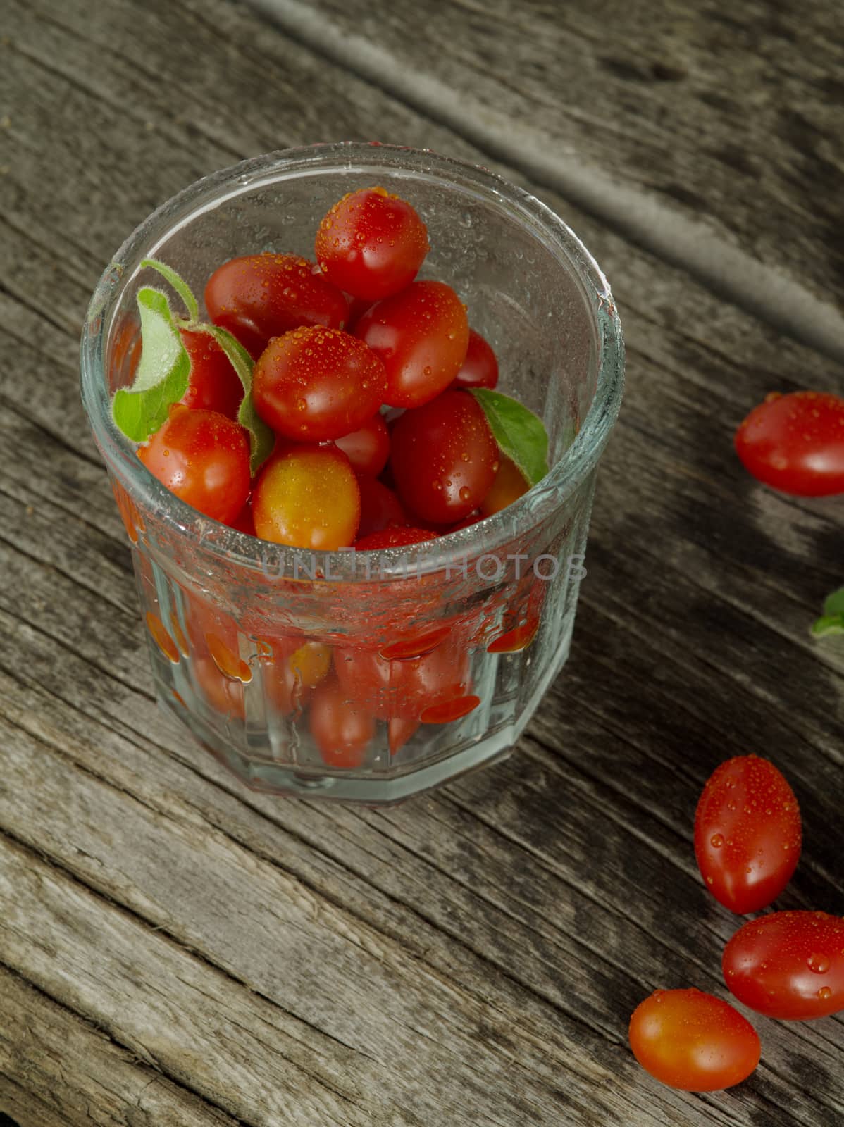 close up view of nice fresh cherry tomatoes on wooden table