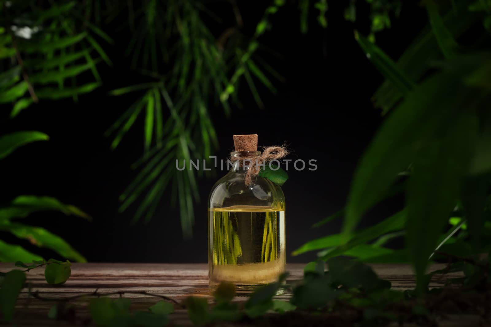 Close up view of spa oil on green background