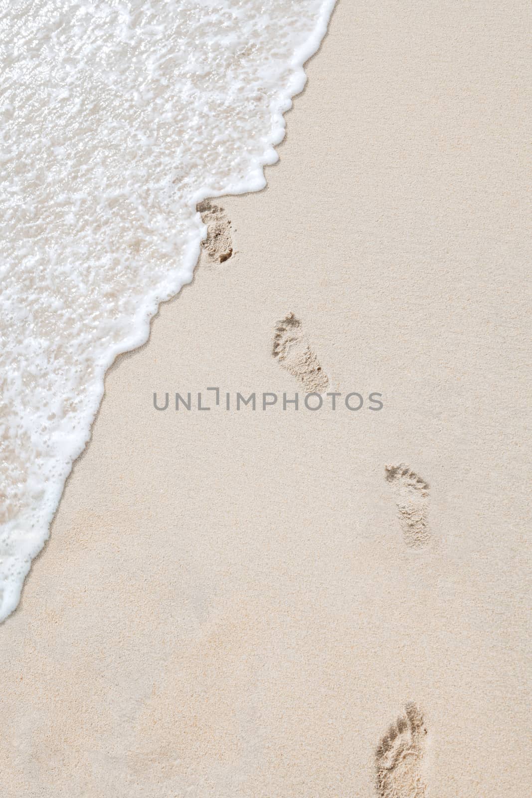 view of human steps on summer sandy beach
