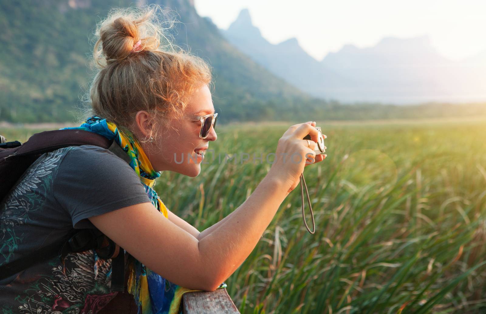 portrait of young beautiful girl is shooting sunset in summer environment