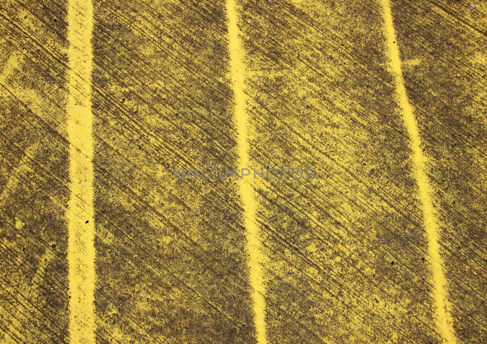 Pattern with yellow stripes painted on asphalt