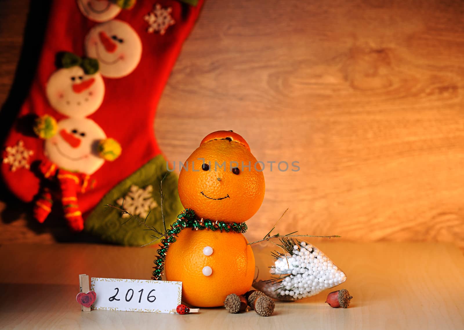 fruit smile snowman toy on wood table with sock