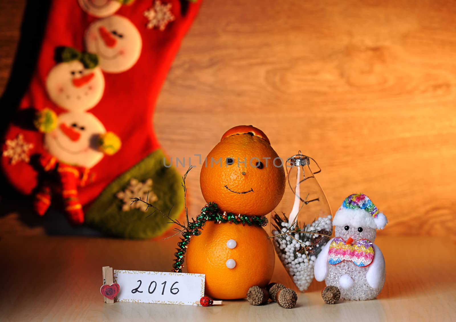 Christmas toy from orange on wood table with sock