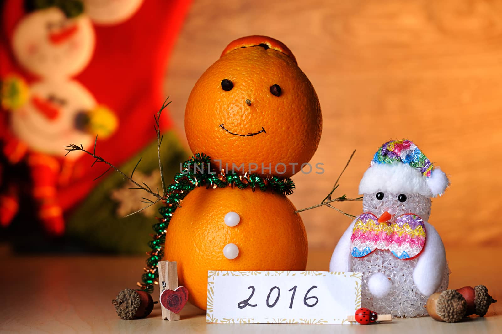 Orange snowman toy decoration on wood table
