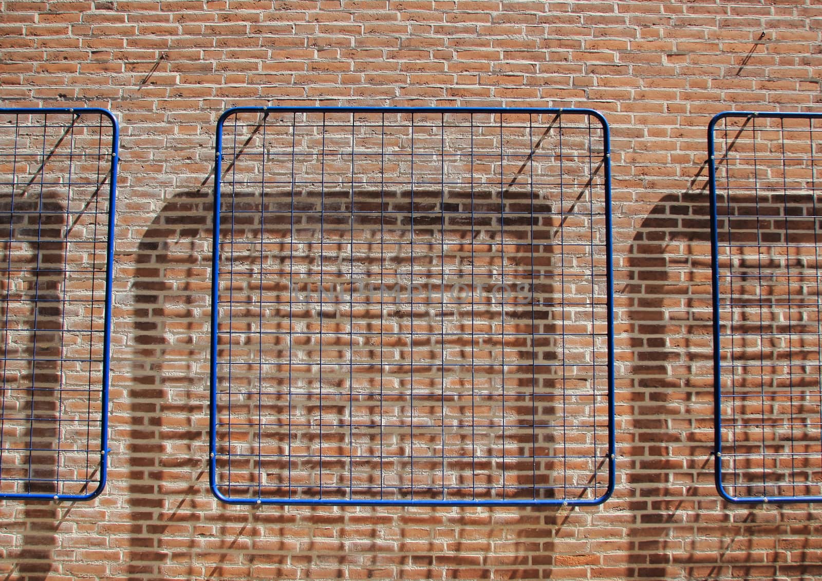 Blue net on brick wall with shadow background