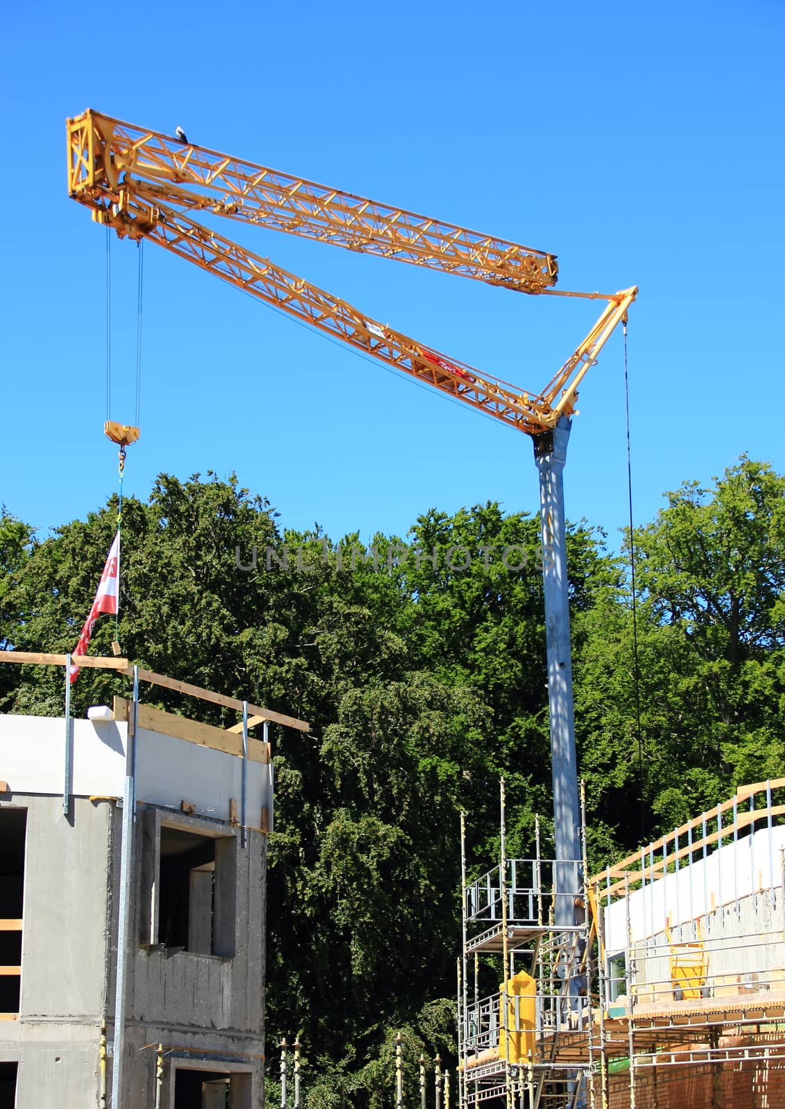 Crane at construction site with blue sky