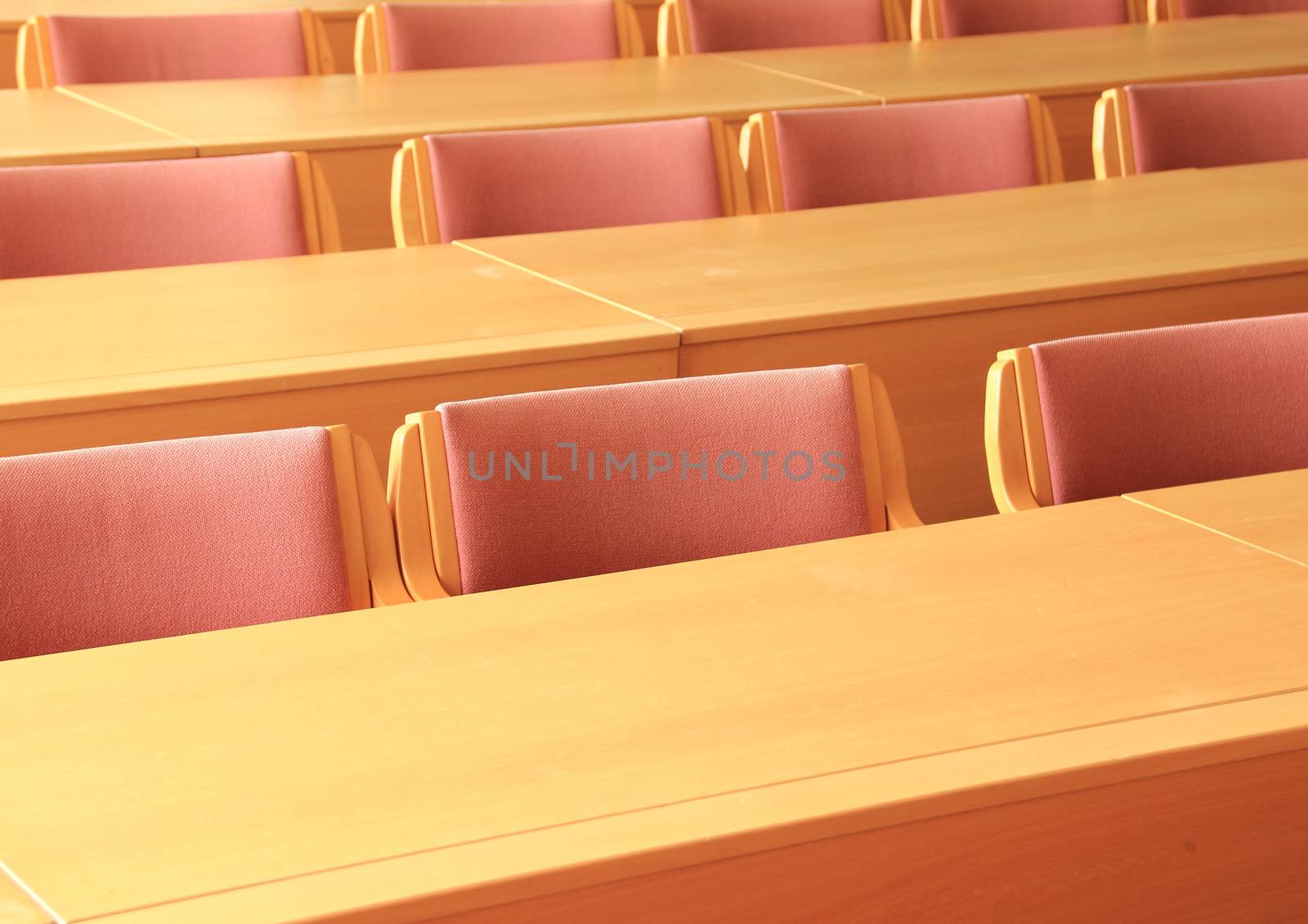 Empty conference room with wooden chairs facing front