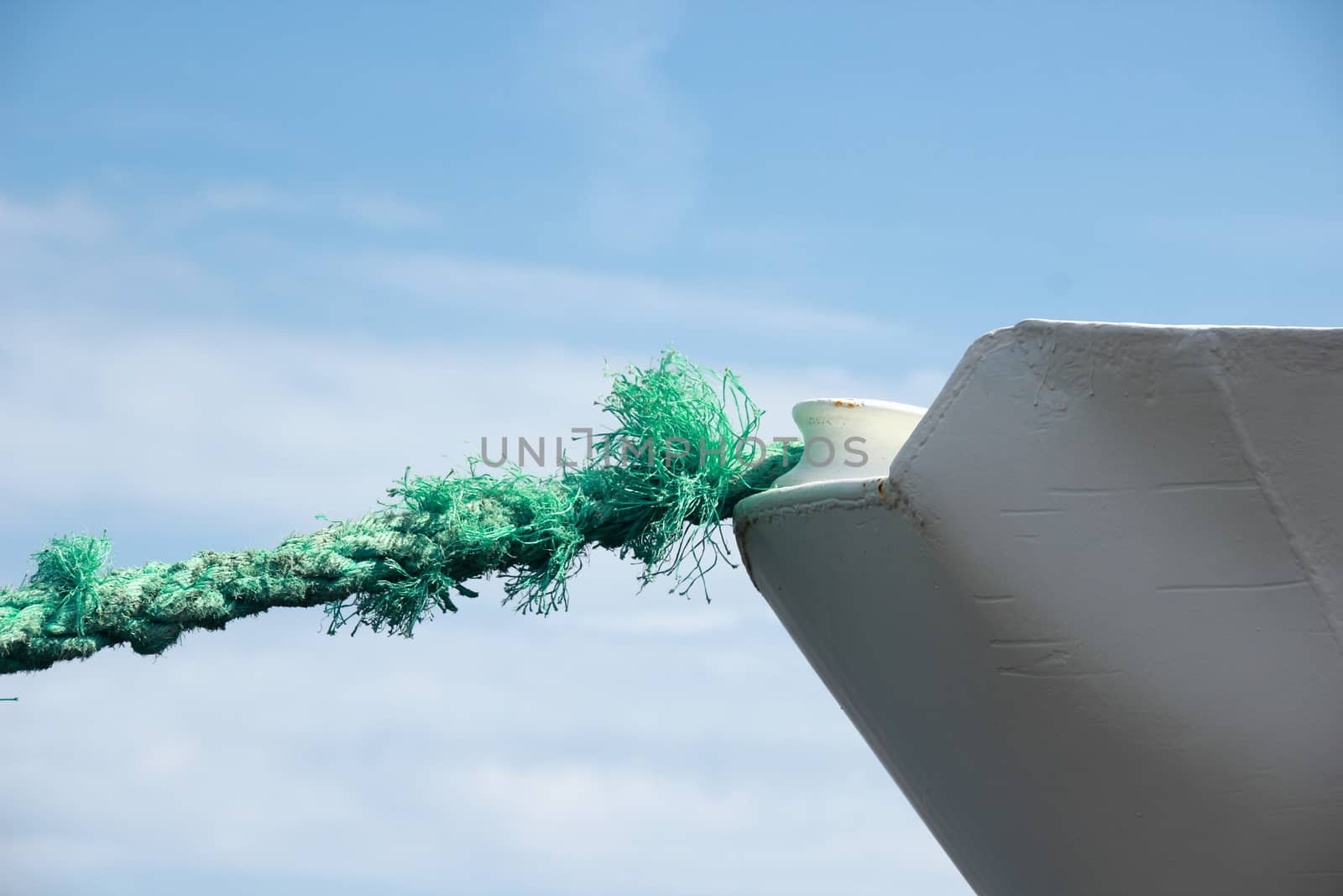 Green worn anchor rope on ship bow