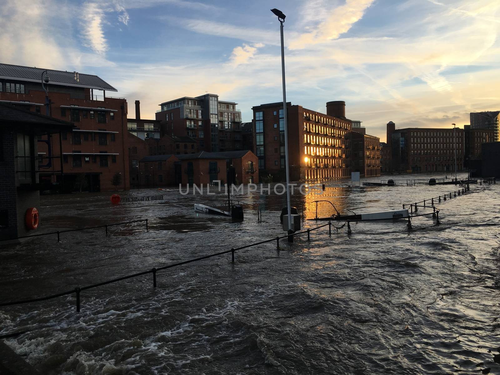 UNITED-KINGDOM, Leeds : Parts of Leeds near the Royal Armouries museum are submerged in flood waters after heavy rainfall hits northern England on December 27, 2015 in West Yorkshire. December 2015 has been the wettest on record for parts of the UK and has seen several communities swamped by rising waters, Met Office figures show. Flood alerts and warnings were issued since the beginning of the month across England and Wales as Storm Desmond, Eva then Frank take hold and bring torrential rain. The leader of Leeds City Council has said the authority had warned the Government that flooding in Leeds was a catastrophe waiting to happen on December 27, 2015. 