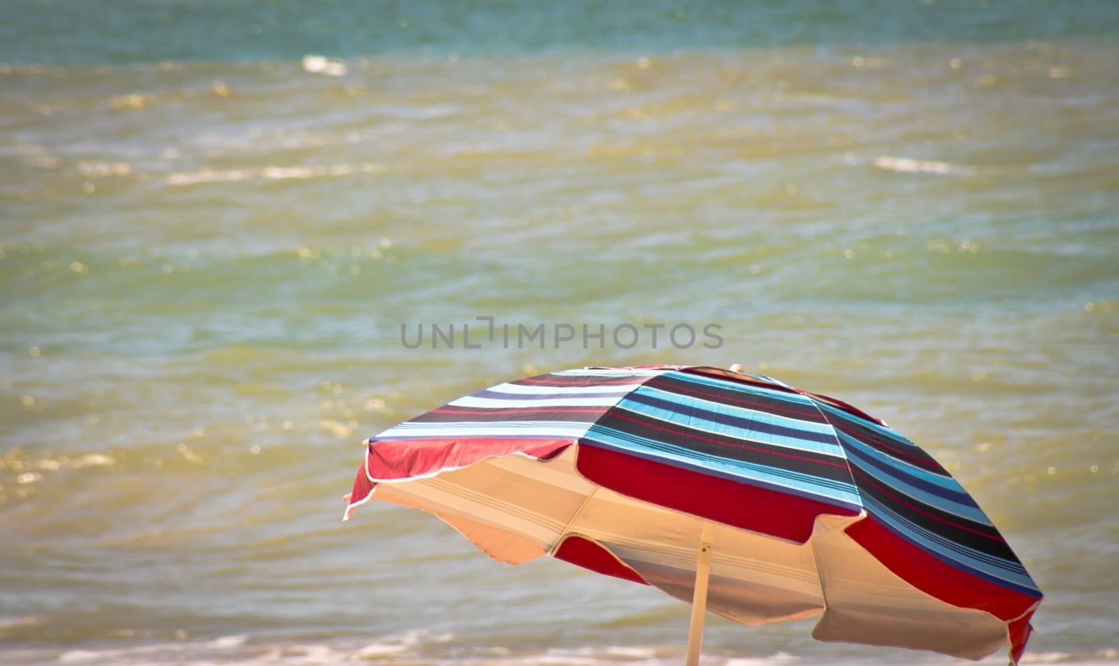 High Section of coloured parasol against sea