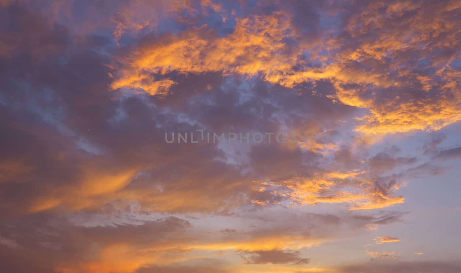 Dramatic purple sky and orange gray cloudy at sunset for background