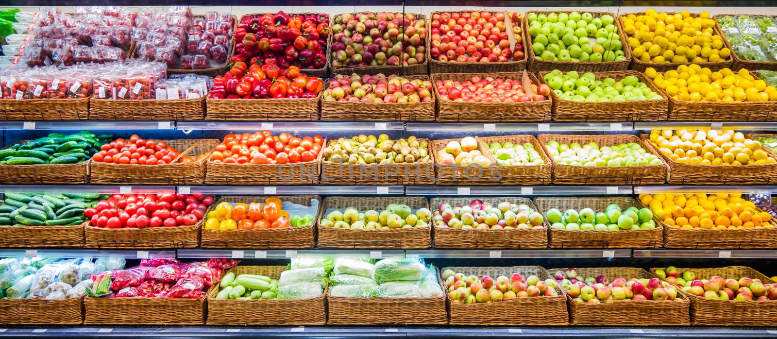 Fresh fruits and vegetables on shelf in supermarket by fascinadora