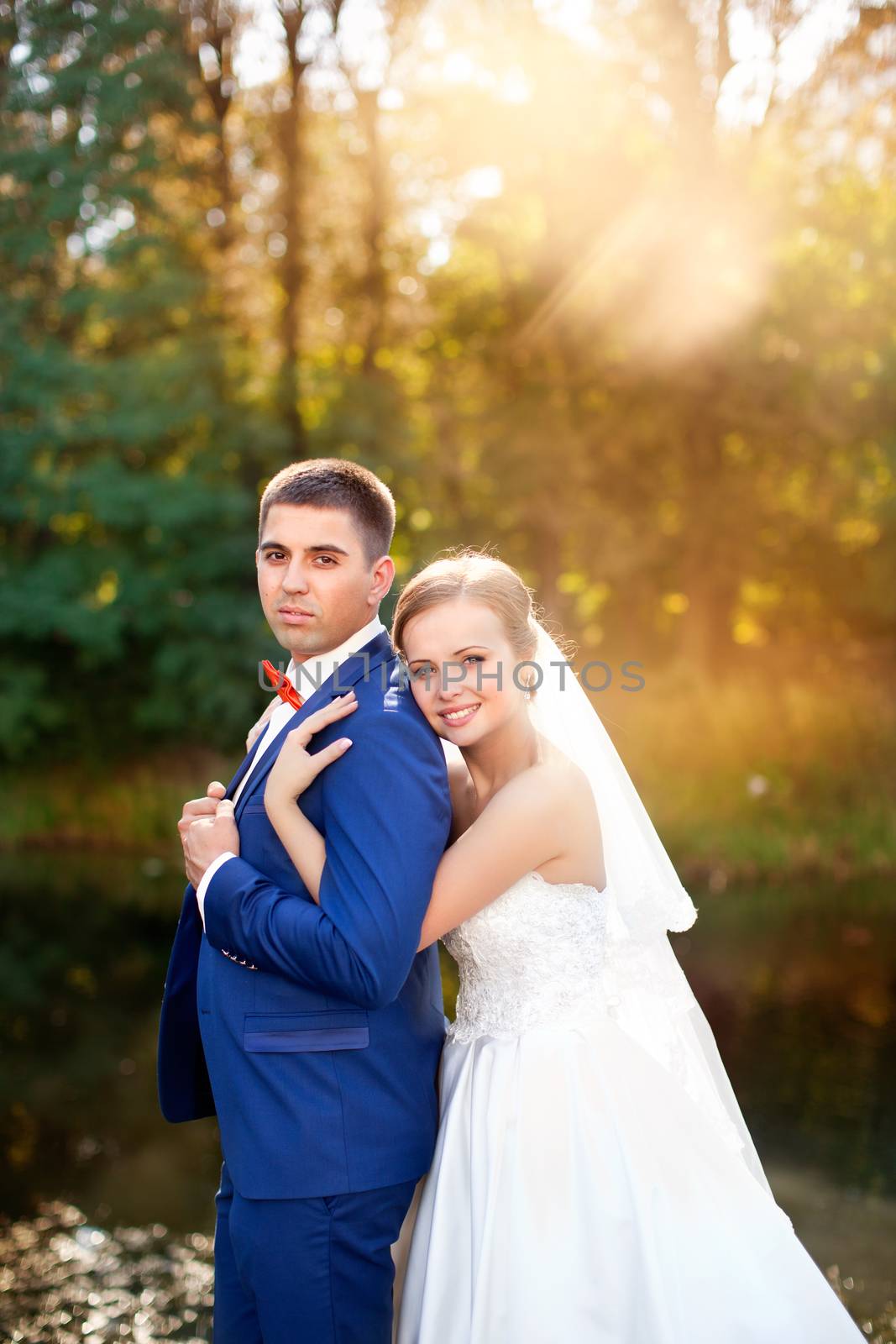 Funny bride and groom on a summer day in the park