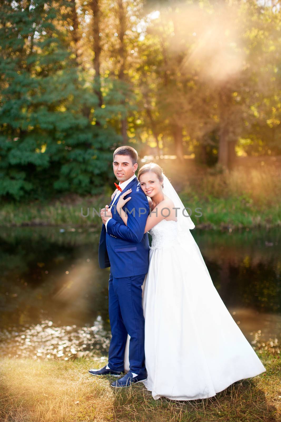 Funny bride and groom on a summer day in the park