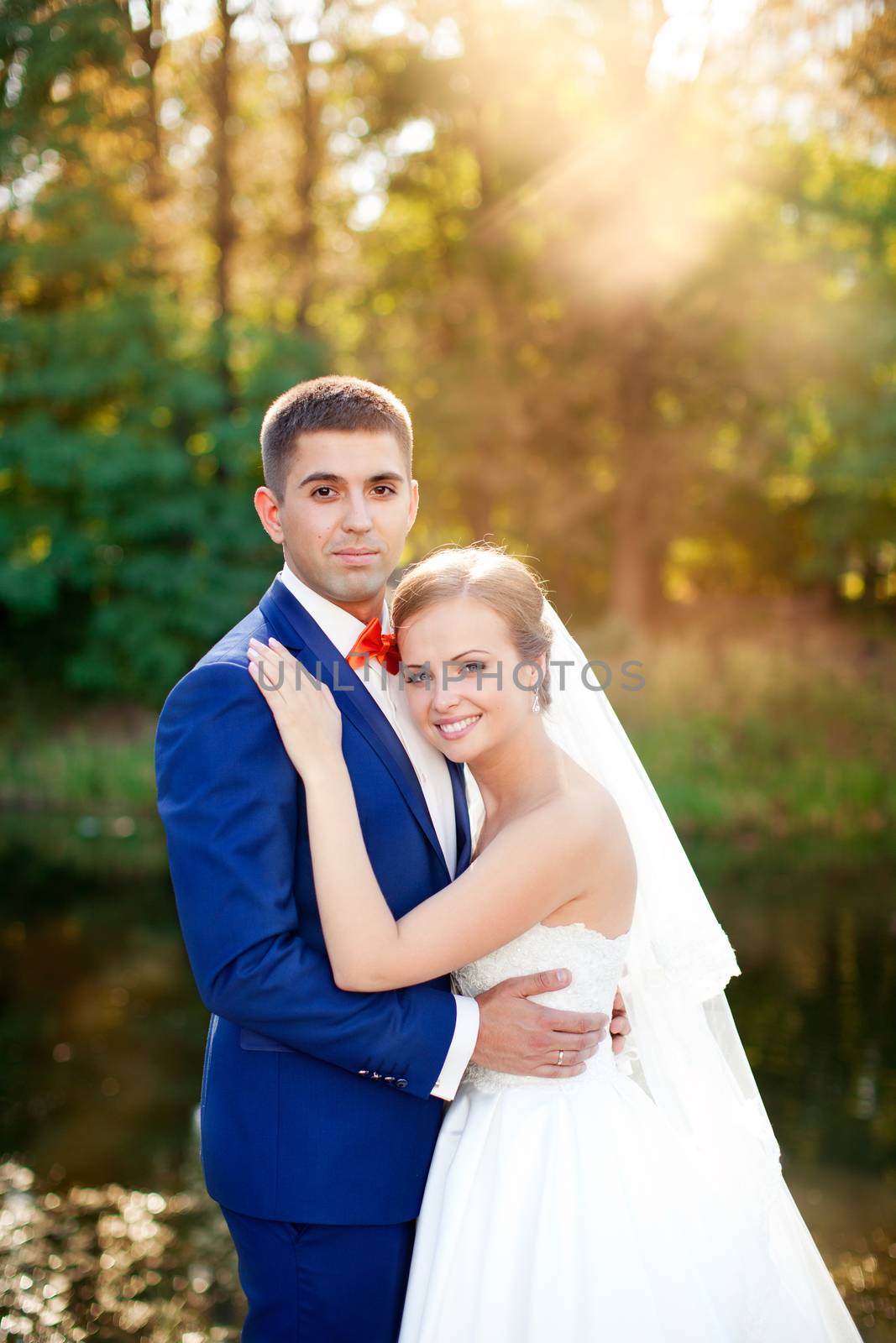 Funny bride and groom on a summer day in the park