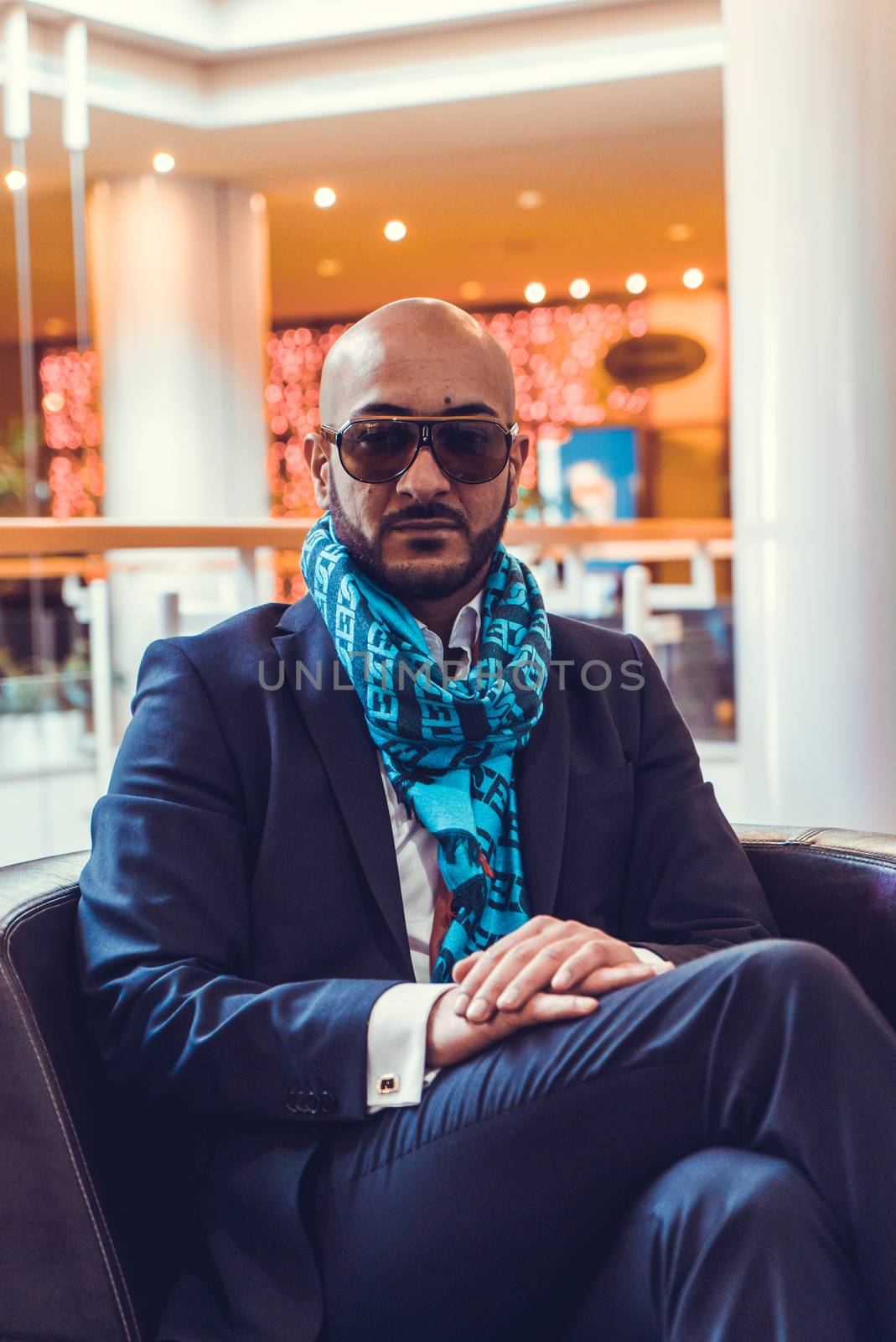 Arab businessman sitting on a sofa in an expensive hotel