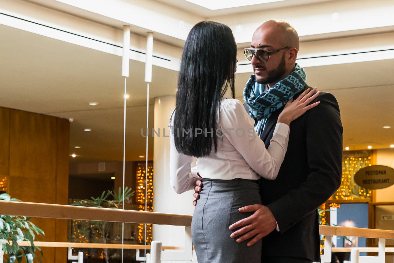 Arab man hugs a pretty woman in the restaurant by vipvn