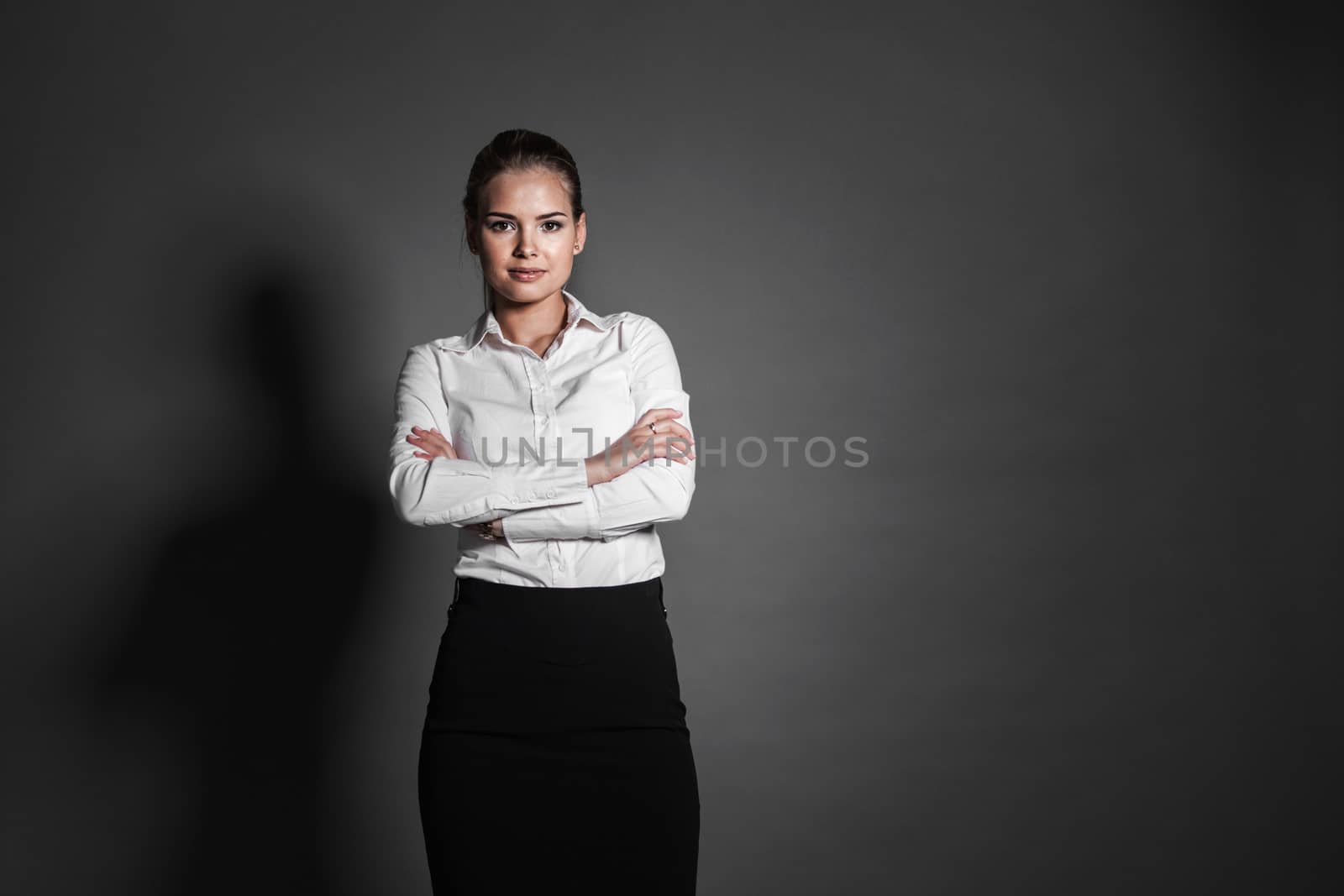 Portrait of young businesswoman on dark background