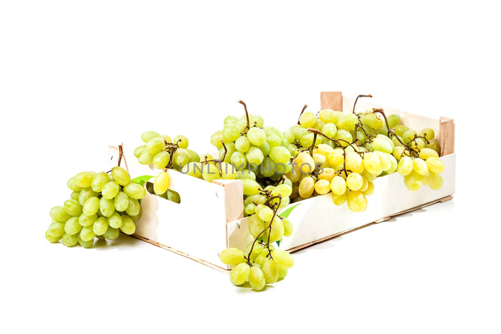 Ripe green grapes in a wooden crate box isolated