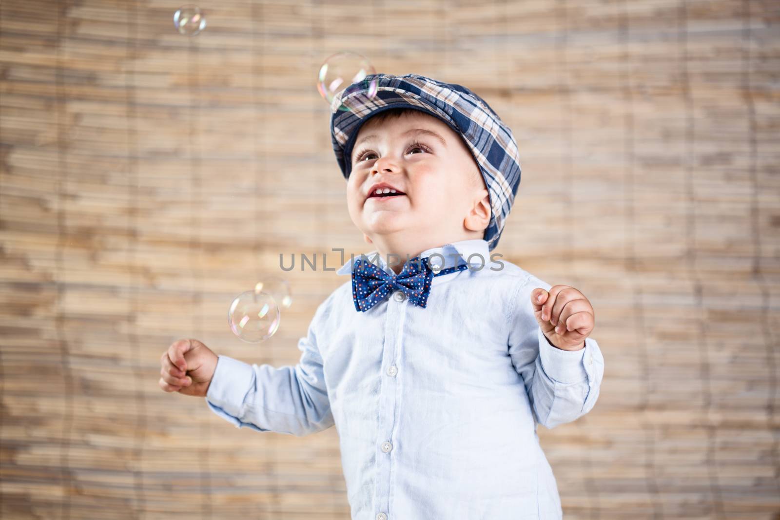 baby boy with gentleman outfit on bamboo background