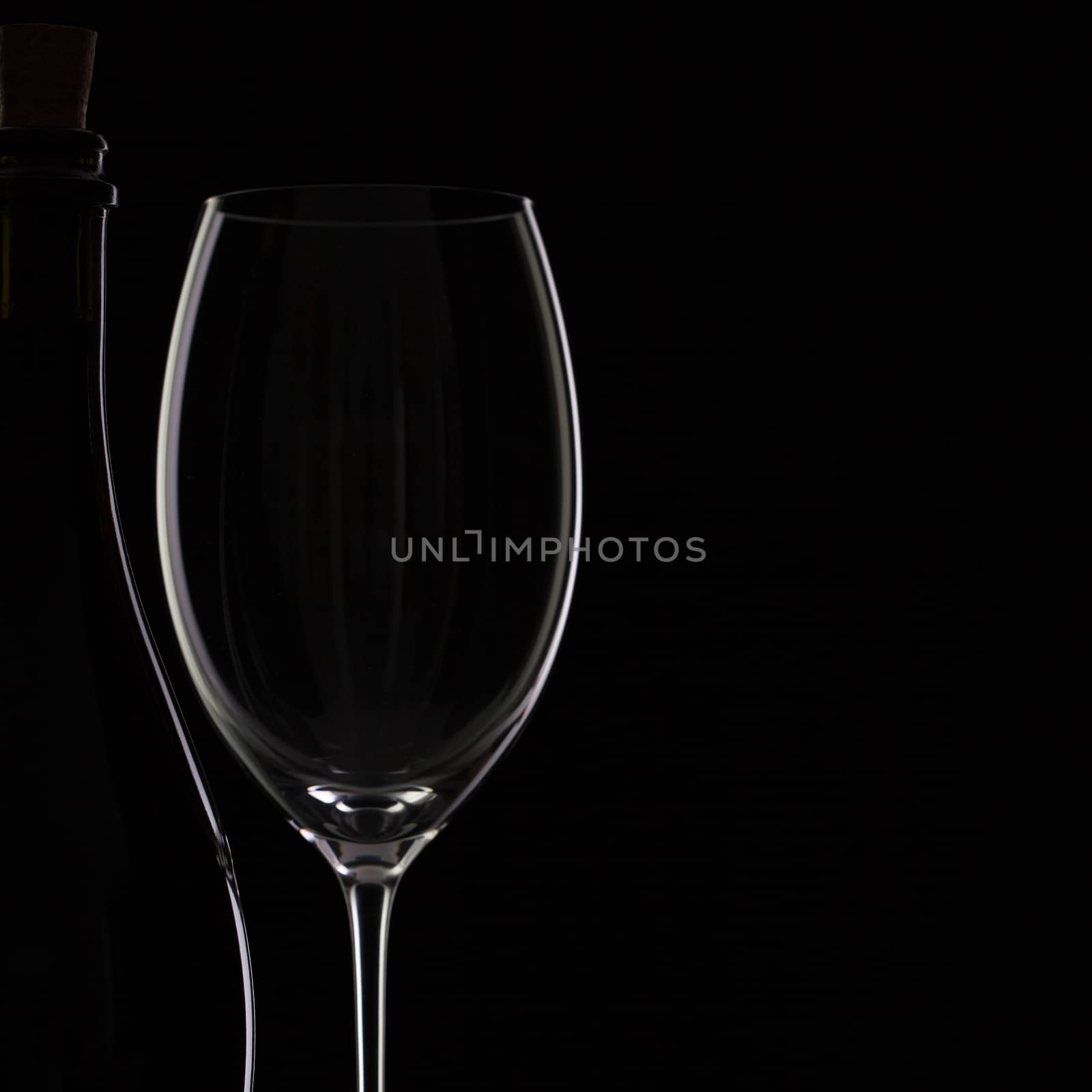 Bottle and glass on the black background by CaptureLight