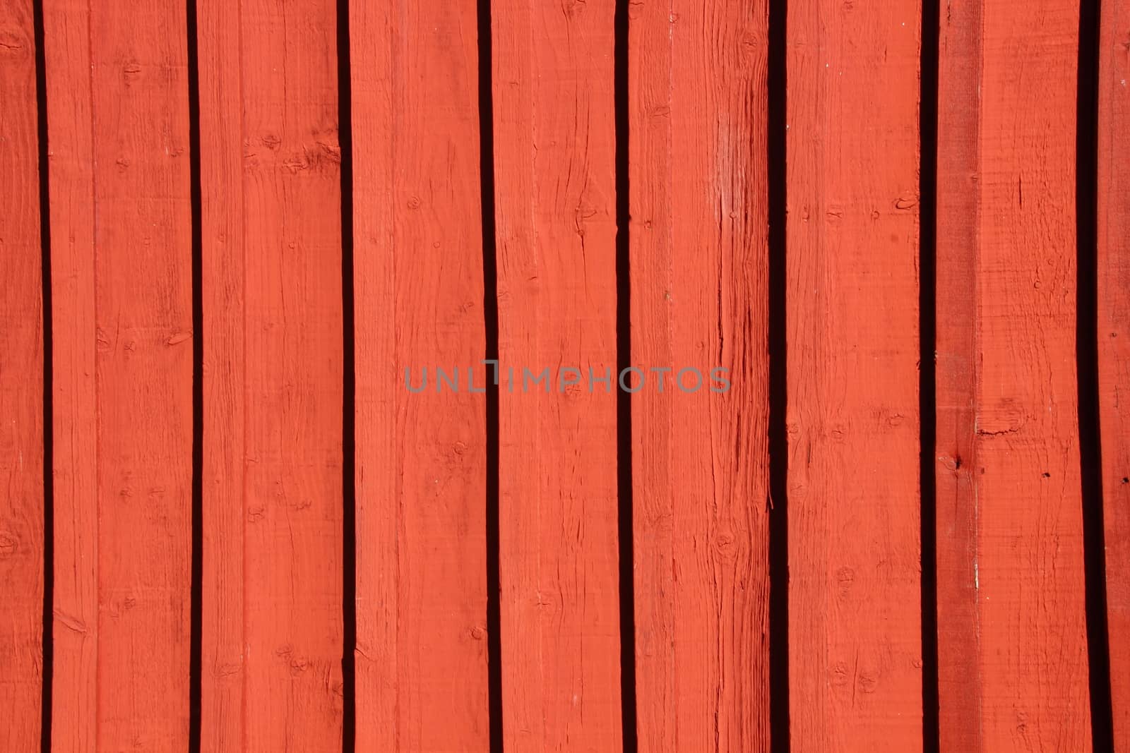 Red painted wooden worn wall of plank background