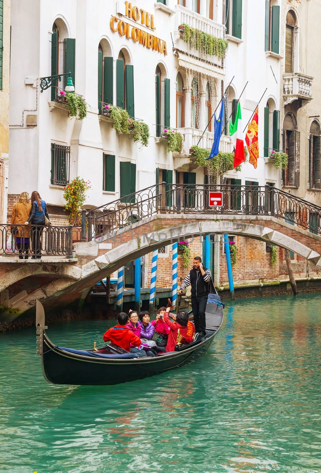 Gondola with tourists in Venice, Italy by AndreyKr