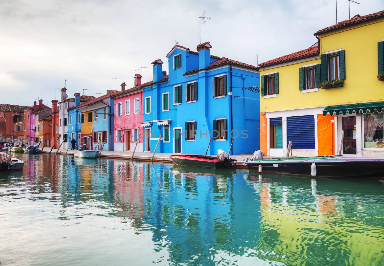 BURANO, ITALY - NOVEMBER 23: Brightly painted houses at the Burano canal on November 23, 2015 in Burano, Venice, Italy. It's an island in the Venetian Lagoon, northern Italy.