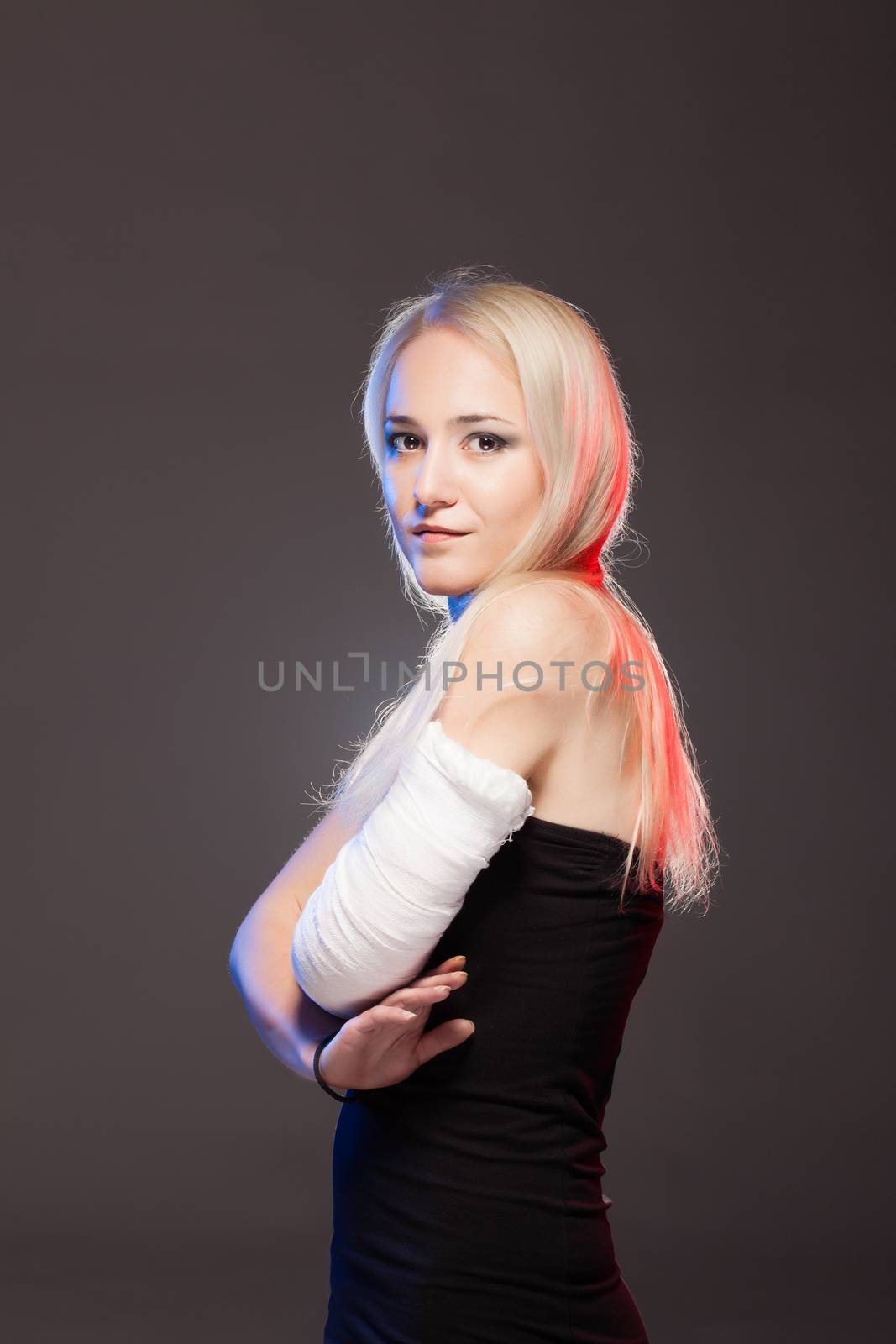 portrait of an elegantl blond girl with a broken arm