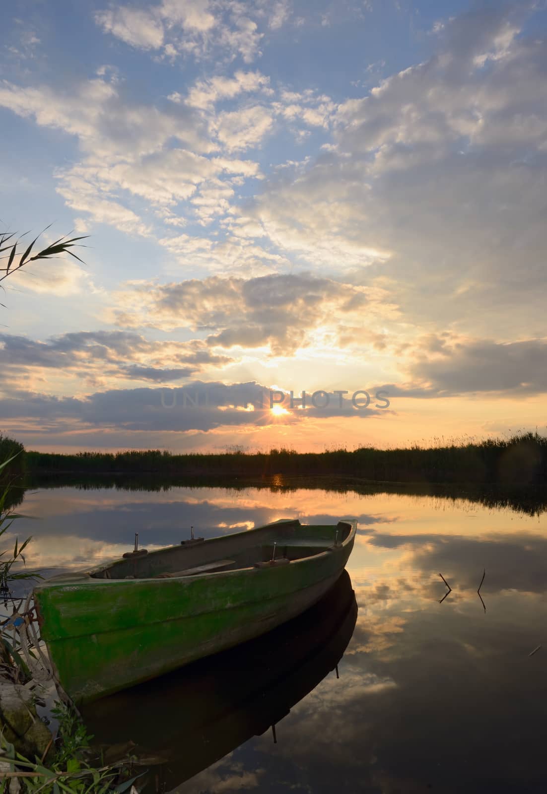 fisherman boat at sunset in summer time