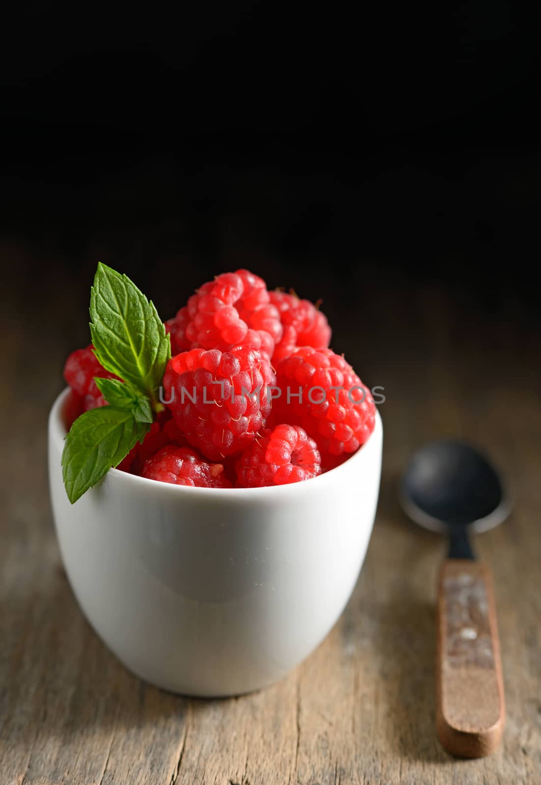 Wild raspberry  in ceramic bowl and mint leaves