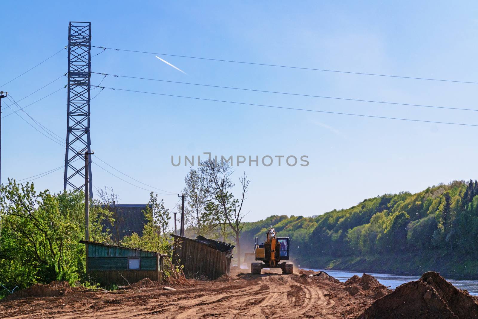 Preparation of the river bank near village for protection against a flood.