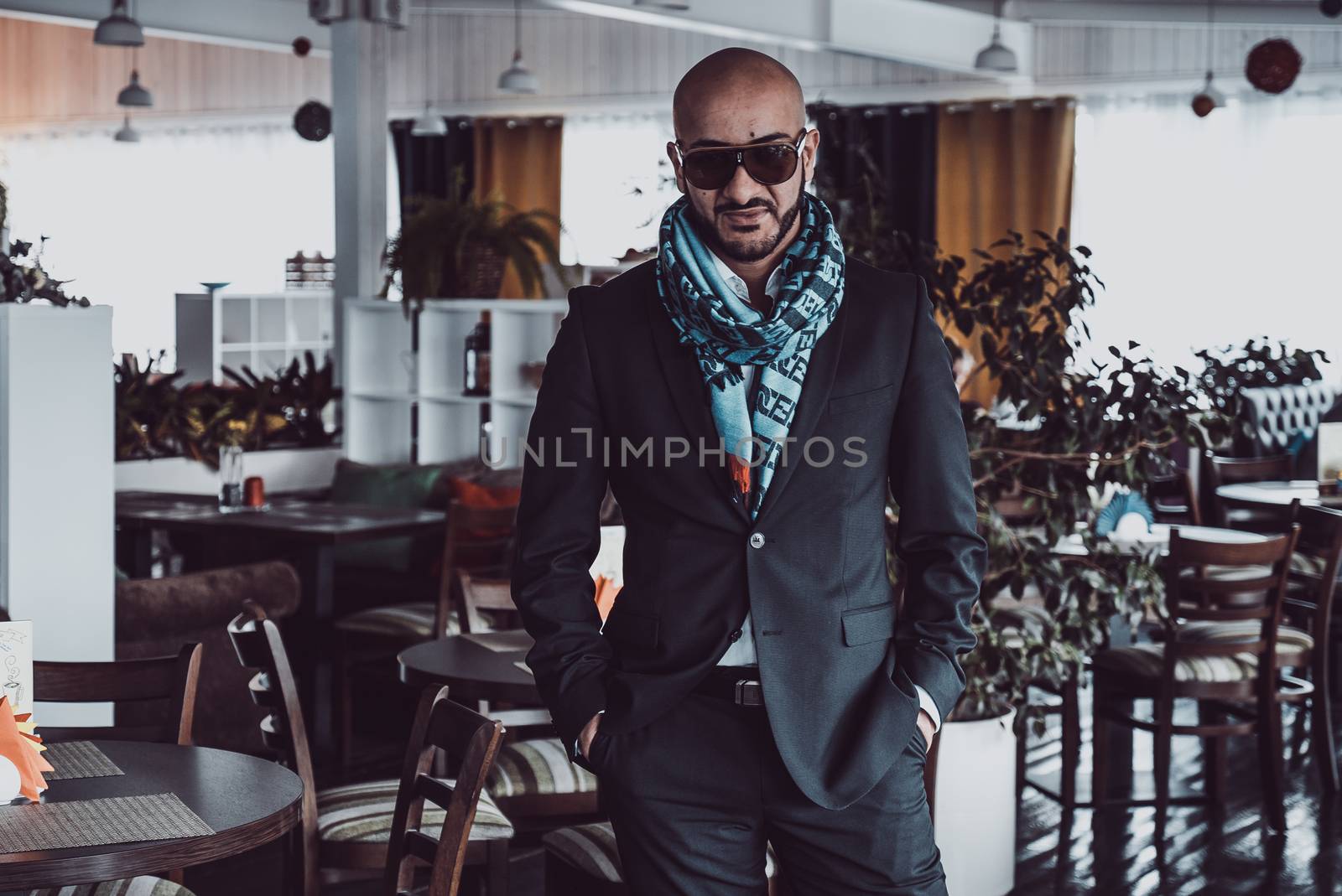 Arab businessman posing in restaurant. Portrait by vipvn