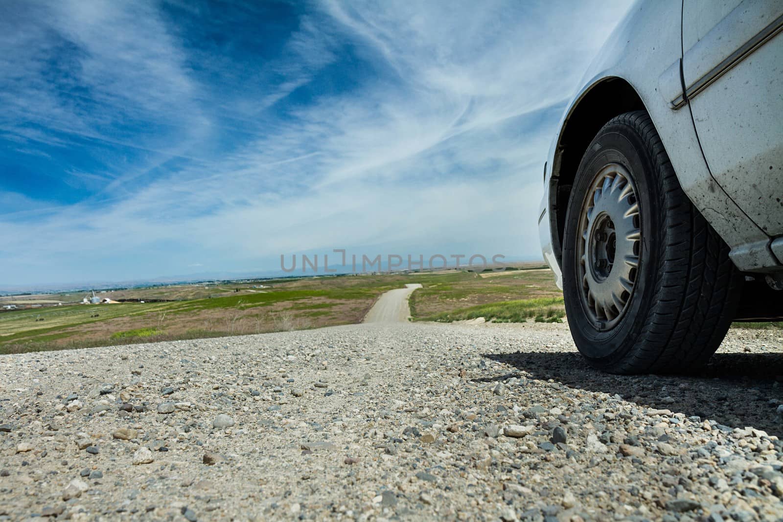 Driving down a dirt road on a nice summer day.