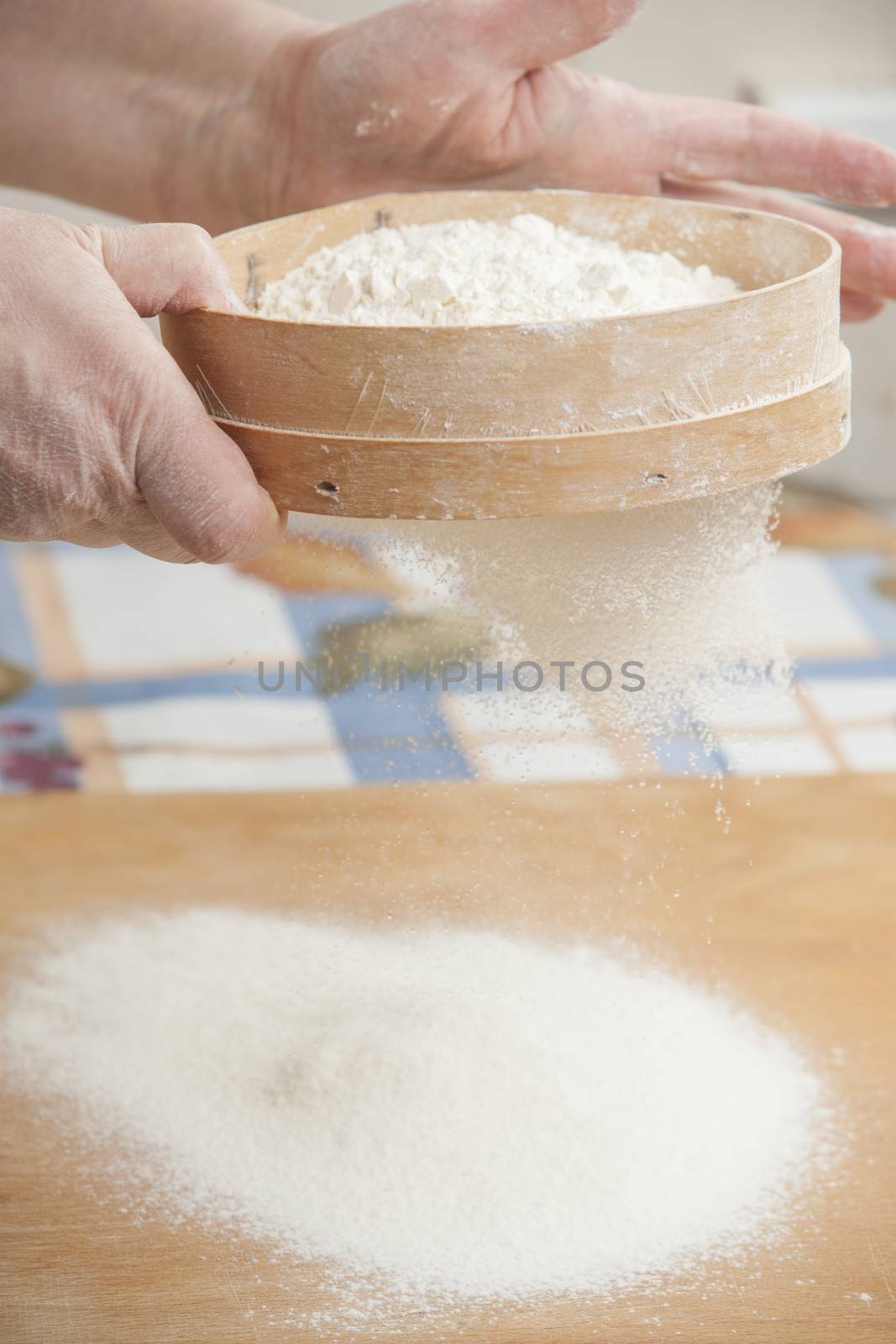 Women's hands preparing flour before baking pie by kozak