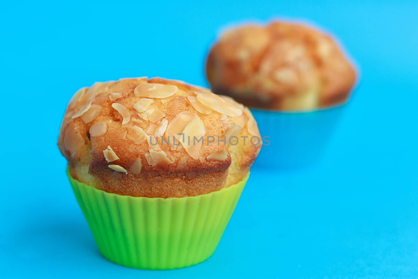 Muffins in silicone tins on a blue background