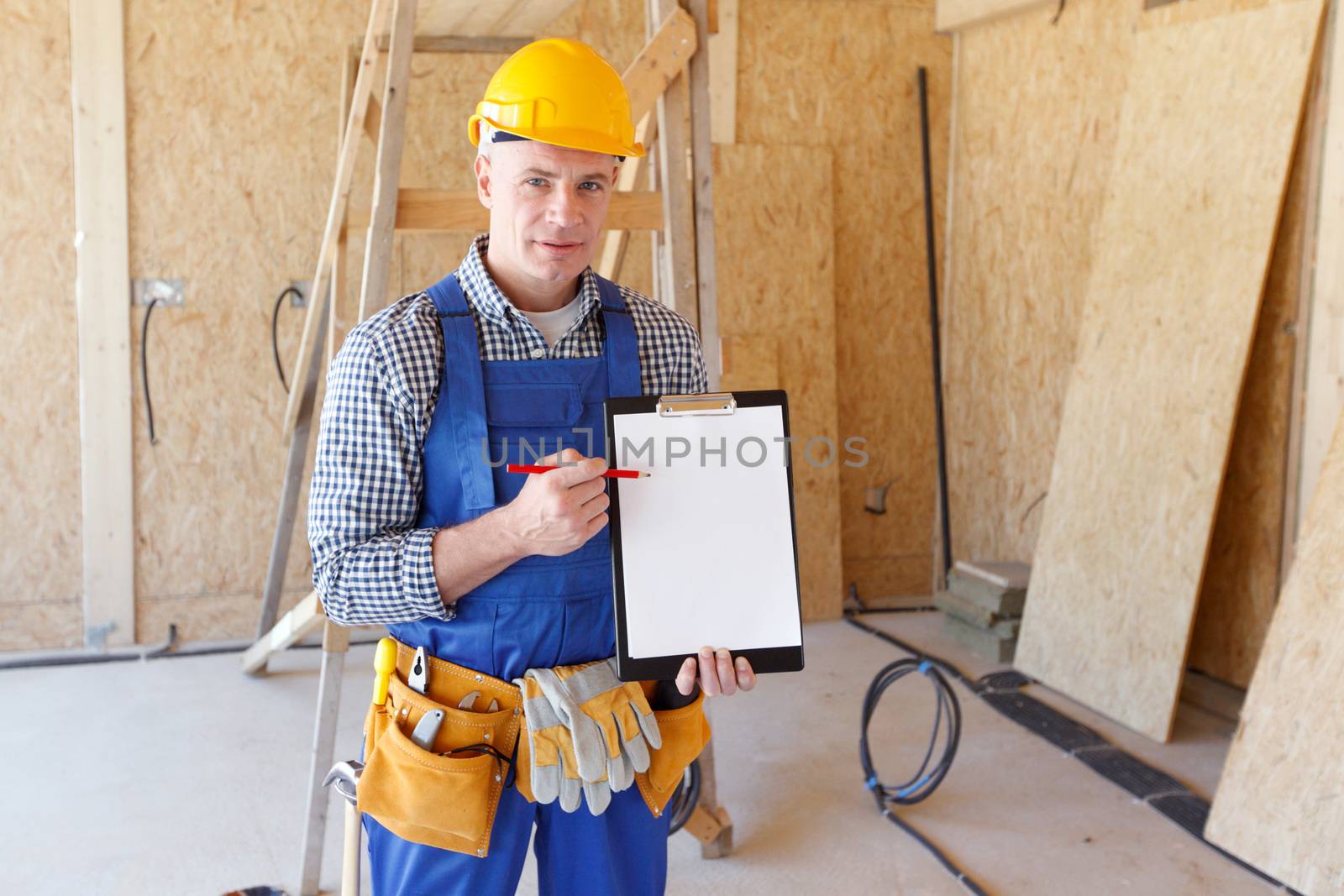 Portrait of foreman pointing at white folder plate