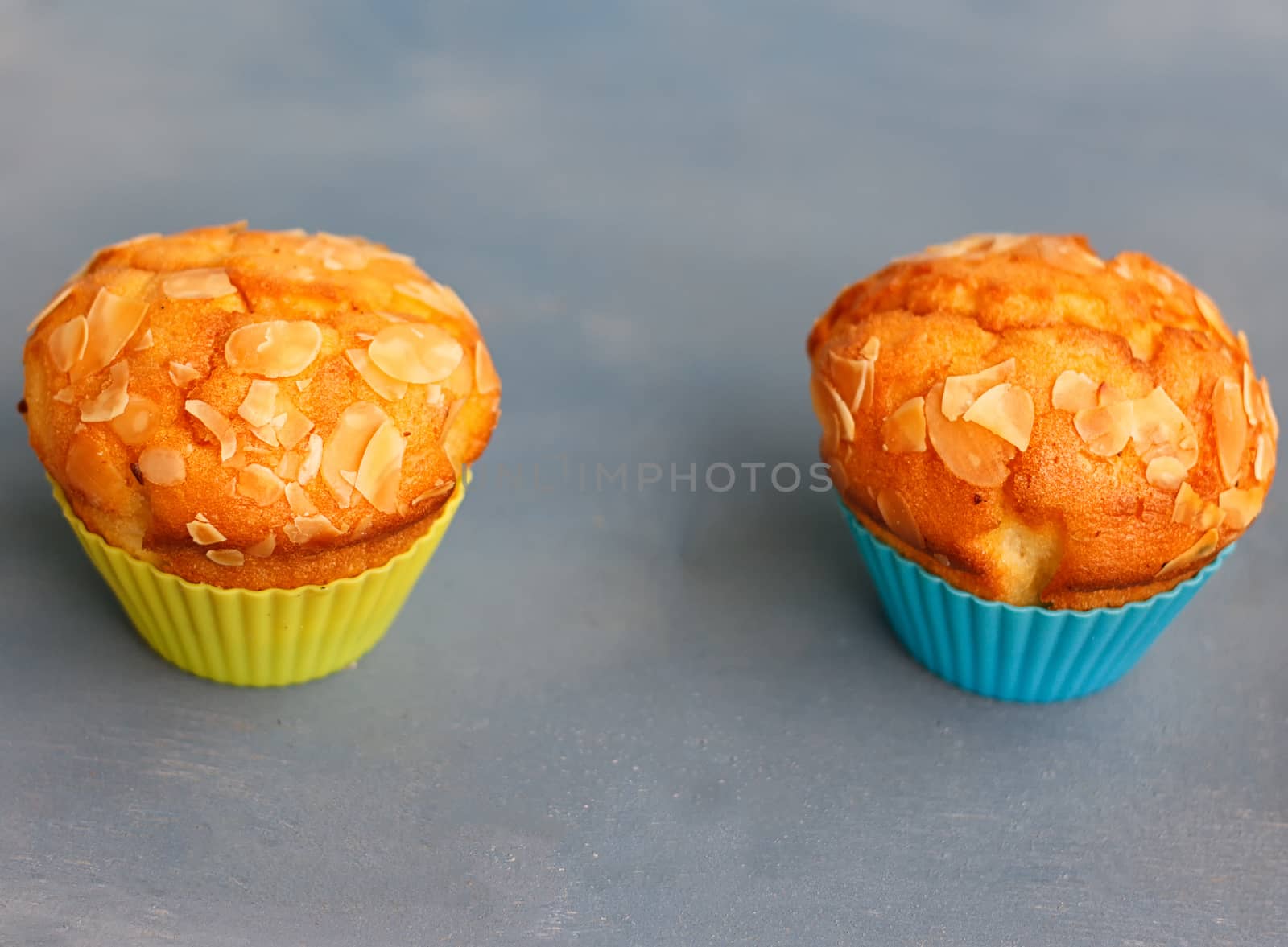 Muffins in silicone tins on a blue background