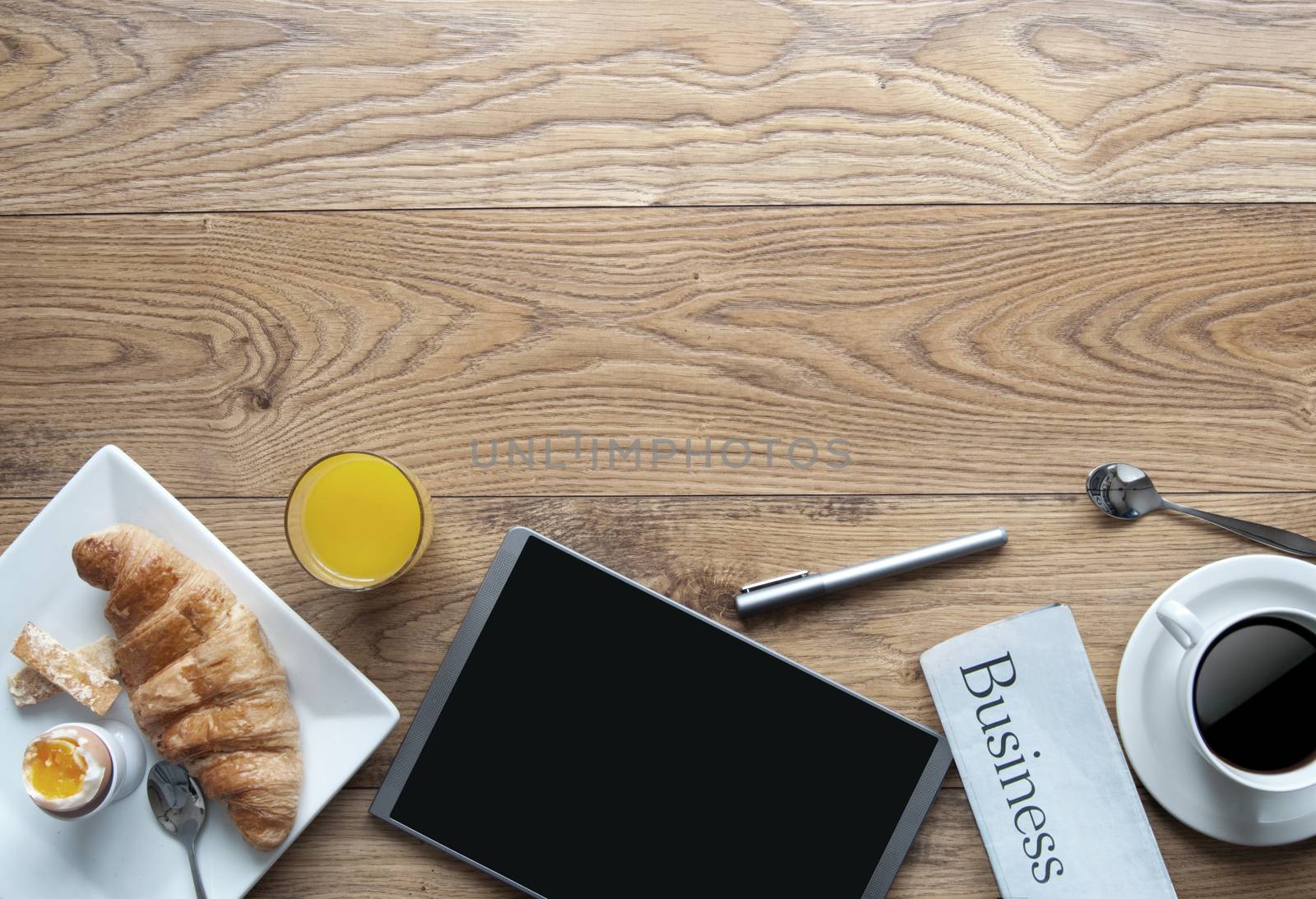 Breakfast with digital tablet on a wooden background with space