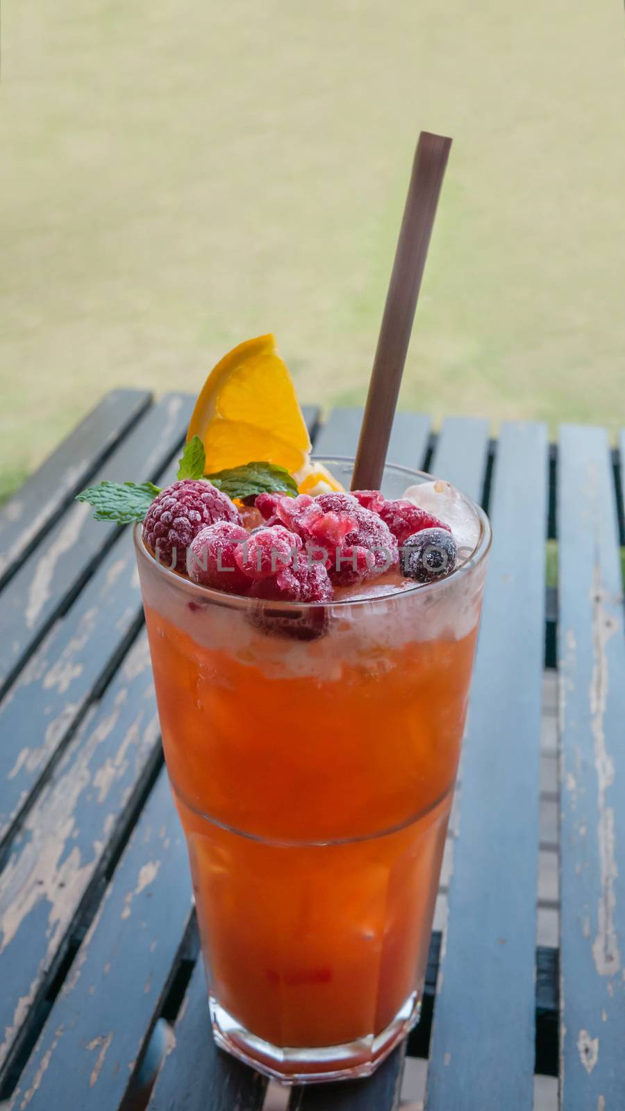 Ice refreshing summer drink with lots of different fruits