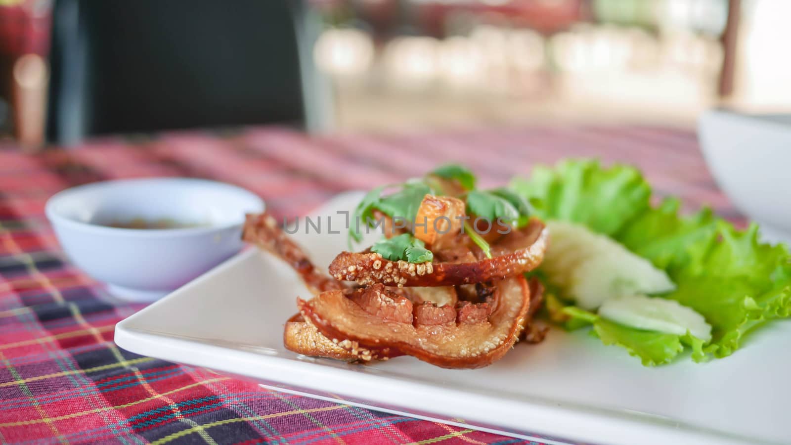 fried pork served with fresh vegetableon white plate , selective focus