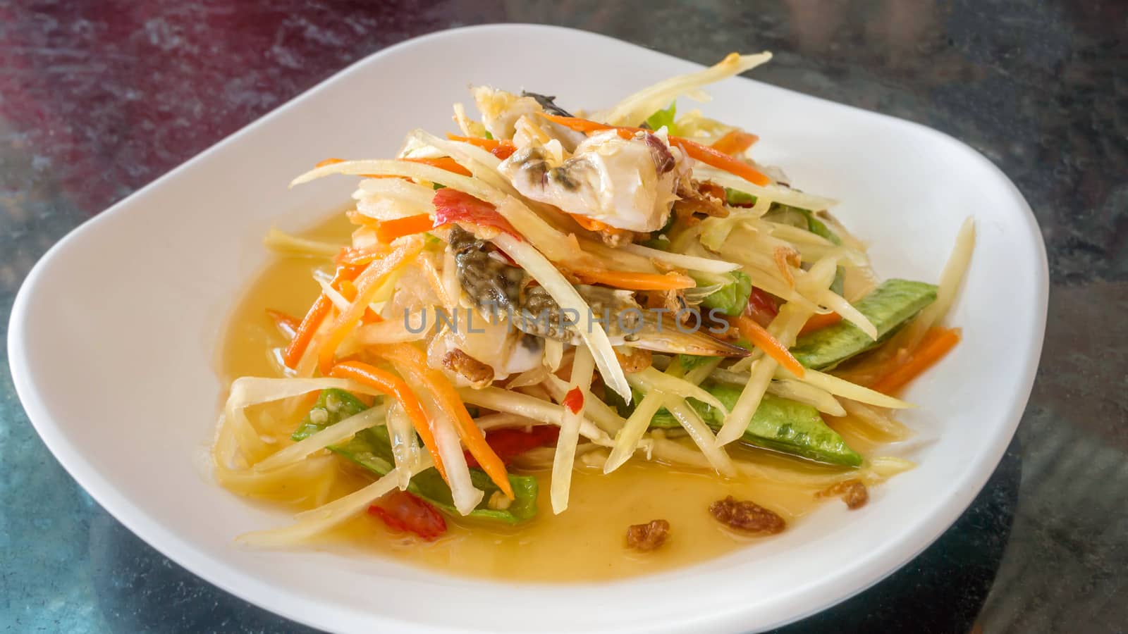 Thai food  spicy papaya salad with pickled brown crab