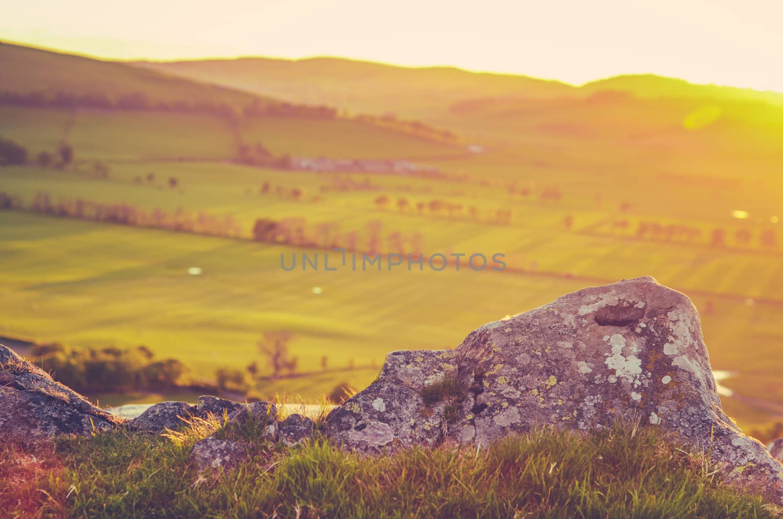 Retro Style Photo Of Scenic Green Rolling Scottish Countryside At Sunset